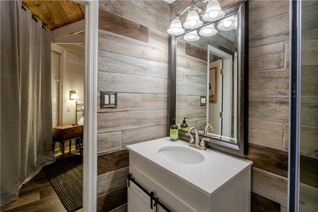150 Treetopper Circle Big Canoe, GA 30143 - Photo 4 of 26 a bathroom with a sink and a mirror
