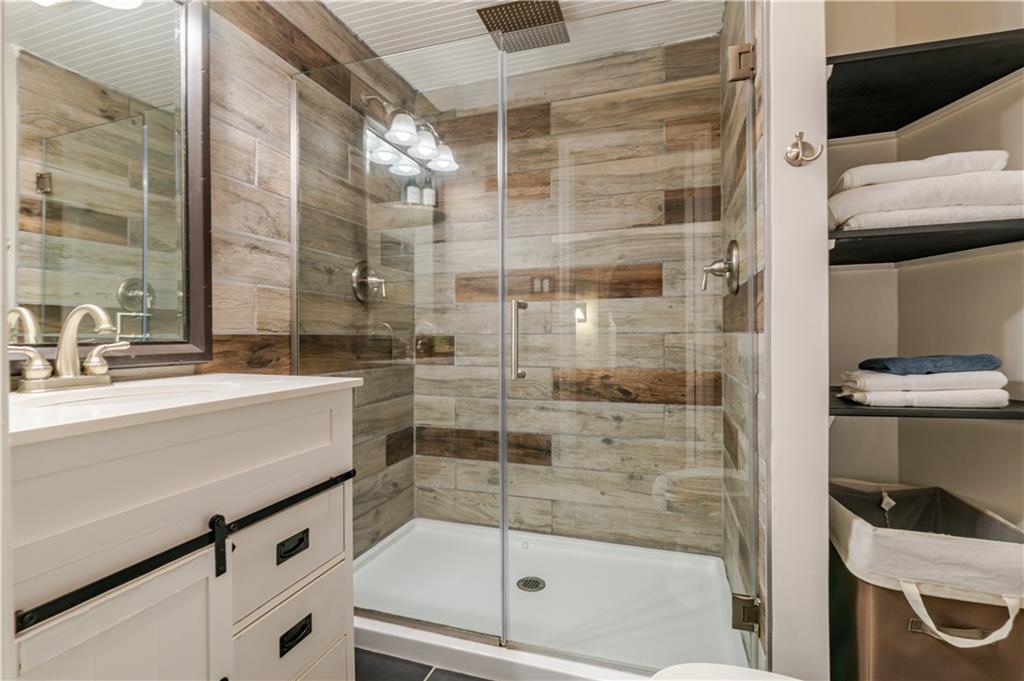150 Treetopper Circle Big Canoe, GA 30143 - Photo 5 of 26 a bathroom with a shower and a sink