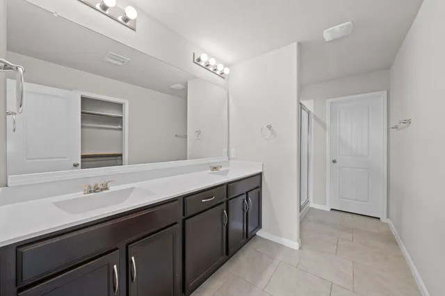 a bathroom with a sink double vanity and a mirror