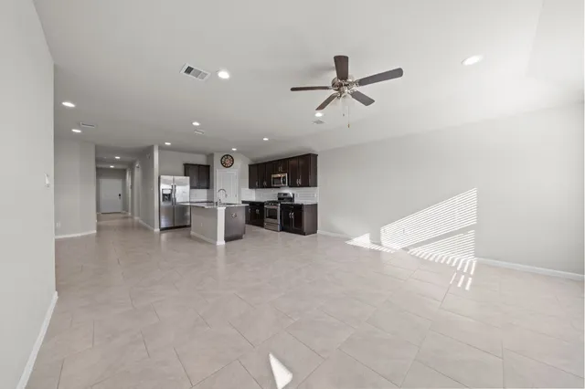 a view of kitchen with furniture and ceiling fan
