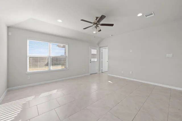 a view of an empty room with a window
