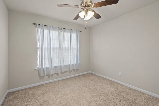 an empty room with a empty space and windows