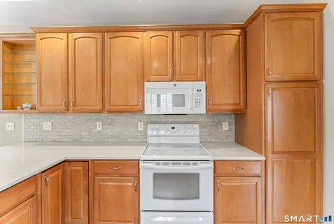 a kitchen with a refrigerator stove and cabinets
