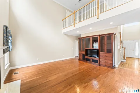 a view of livingroom with hardwood and hallway