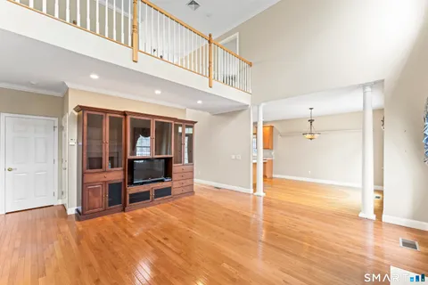 a view of a livingroom with furniture and an empty room