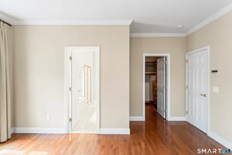 an empty room with wooden floor and closet