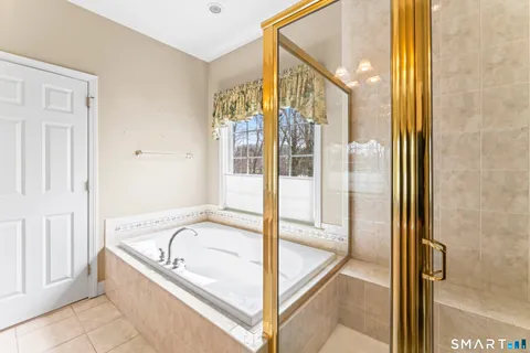 a bathroom with a bathtub and shower
