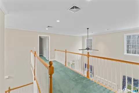 a view of a hallway with stairs