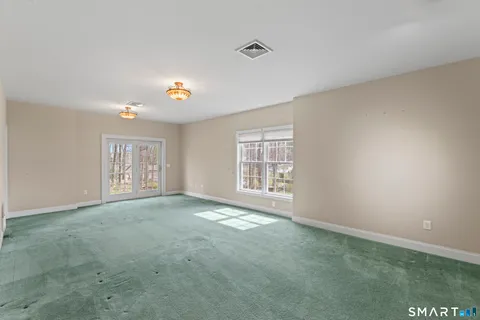 an empty room with windows and closet