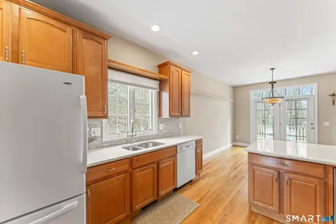 a large kitchen with stainless steel appliances a large window