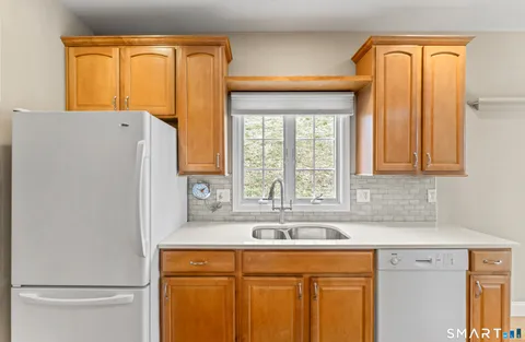 a kitchen with a refrigerator and a sink