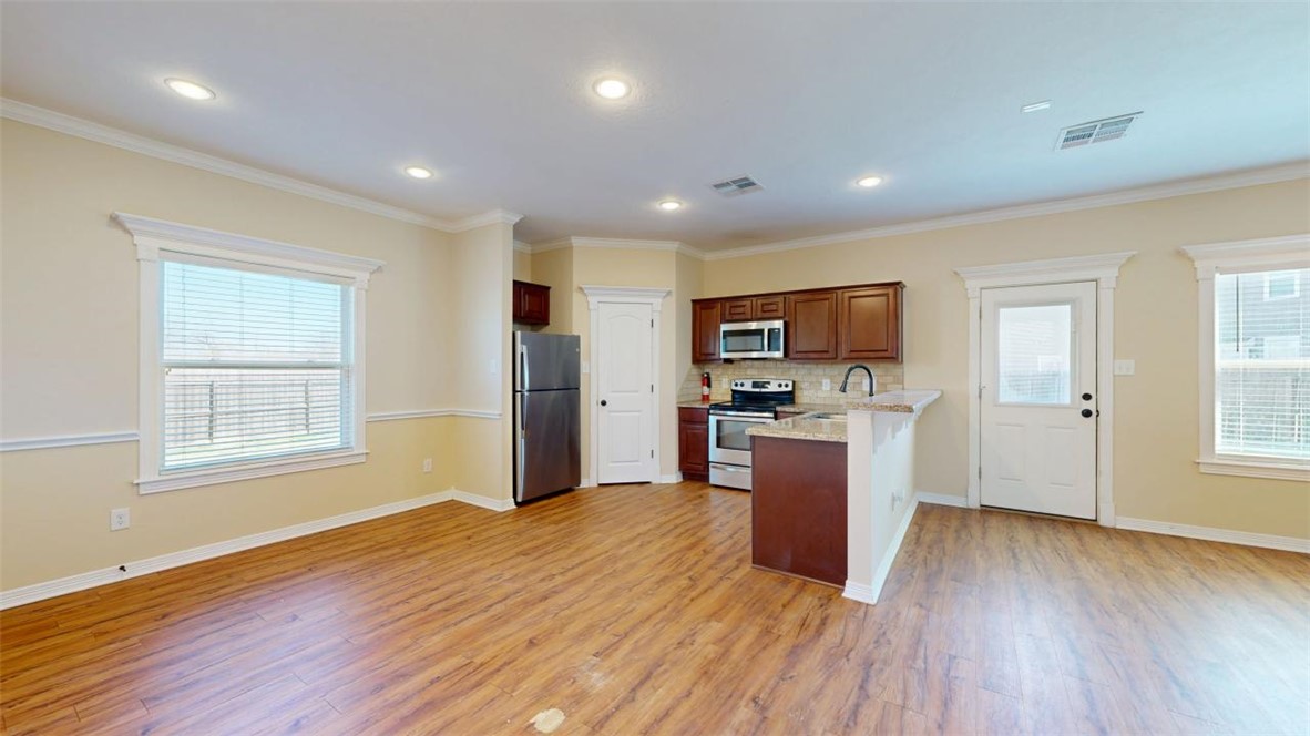 2900 Horseback Court College Station, TX 77845 - Photo 46 of 47 a view of a kitchen and microwave with wooden floor