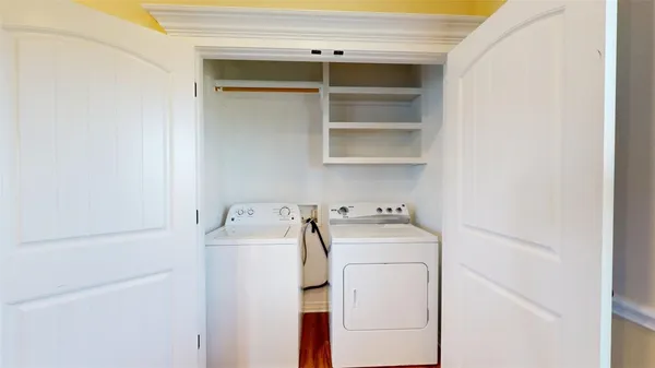 a view of a room with wooden floor and window