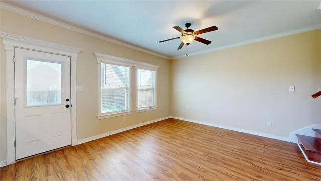 a view of hallway with wooden floor and chandelier