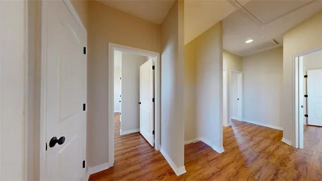 a view of hallway with wooden floor