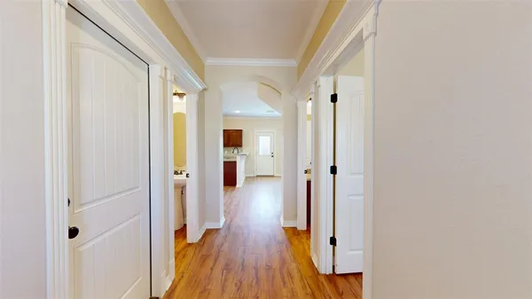 a view of a hallway with wooden floor and staircase