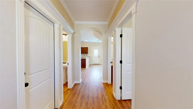 a view of a hallway with wooden floor and staircase