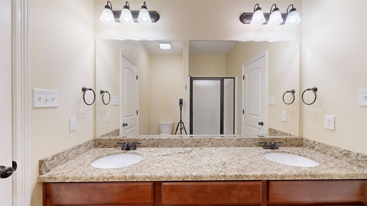 2900 Horseback Court College Station, TX 77845 - Photo 31 of 47 a bathroom with a granite countertop sink and a mirror
