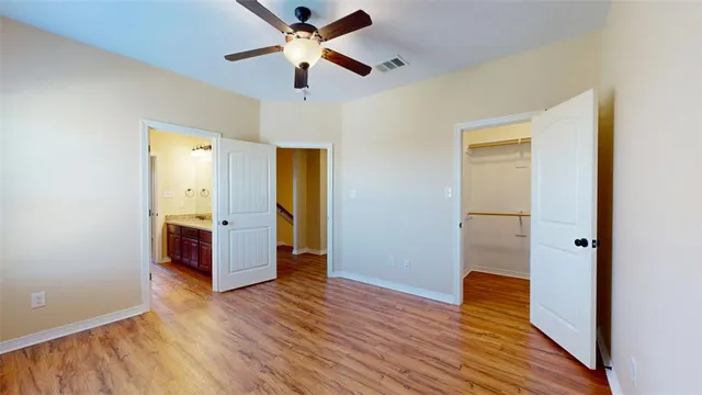 a view of empty room with wooden floor
