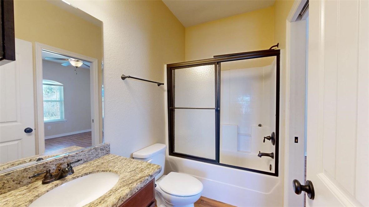 2900 Horseback Court College Station, TX 77845 - Photo 38 of 47 a bathroom with a granite countertop sink toilet and shower