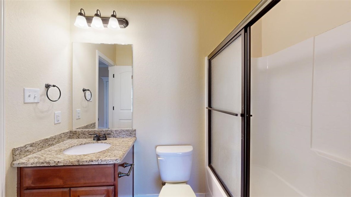 2900 Horseback Court College Station, TX 77845 - Photo 7 of 47 a bathroom with a granite countertop sink toilet and mirror