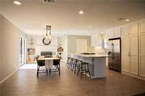 a kitchen with a table chairs and a refrigerator