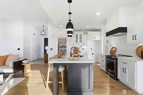 a kitchen with stainless steel appliances a stove refrigerator sink and cabinets