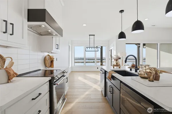 a kitchen with a sink appliances and cabinets
