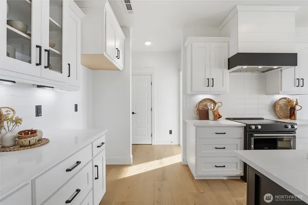a kitchen with cabinets and appliances
