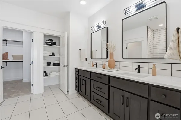 a spacious bathroom with a double vanity sink mirror and double