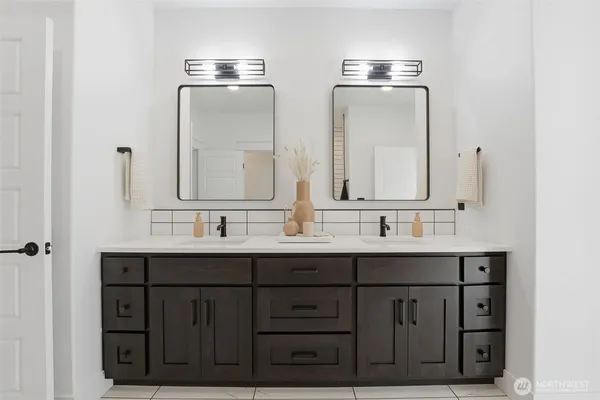 a bathroom with two sink and a mirror