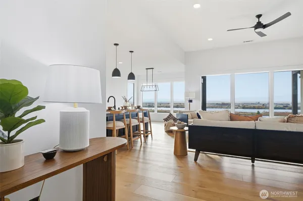 a living room with lots of furniture and view of kitchen