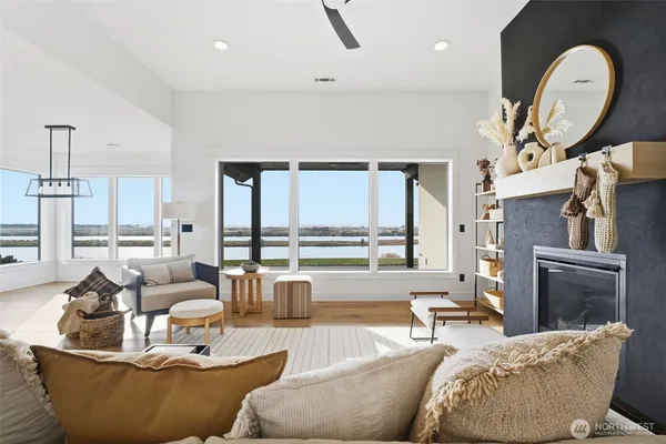 a living room with furniture fireplace and a large window