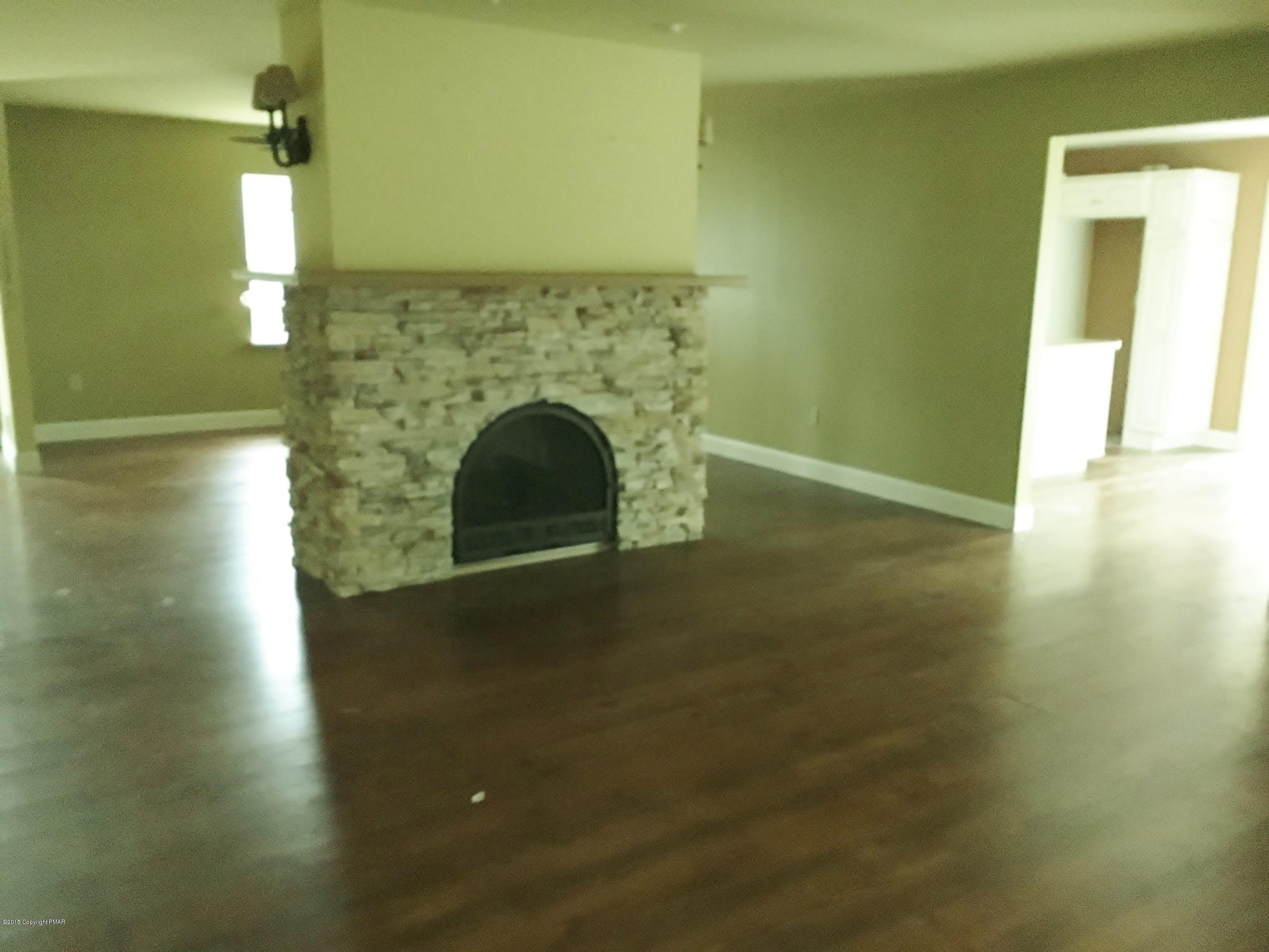 341 Ridge Circle Cresco, PA 18326 - Photo 2 of 24 a view of empty room with window and fireplace