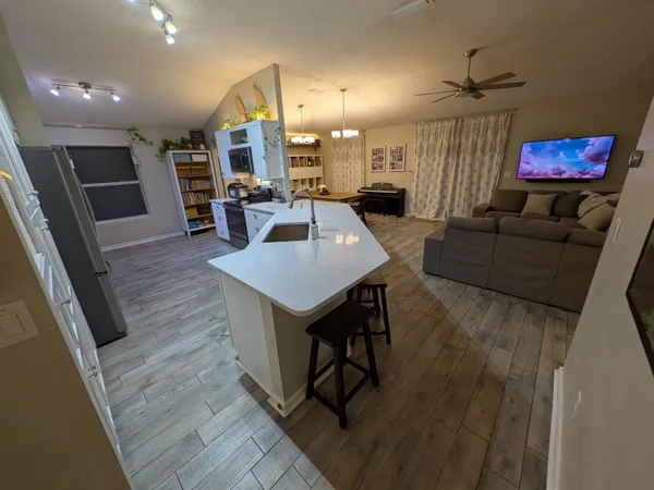 a living room with furniture and a wooden floor