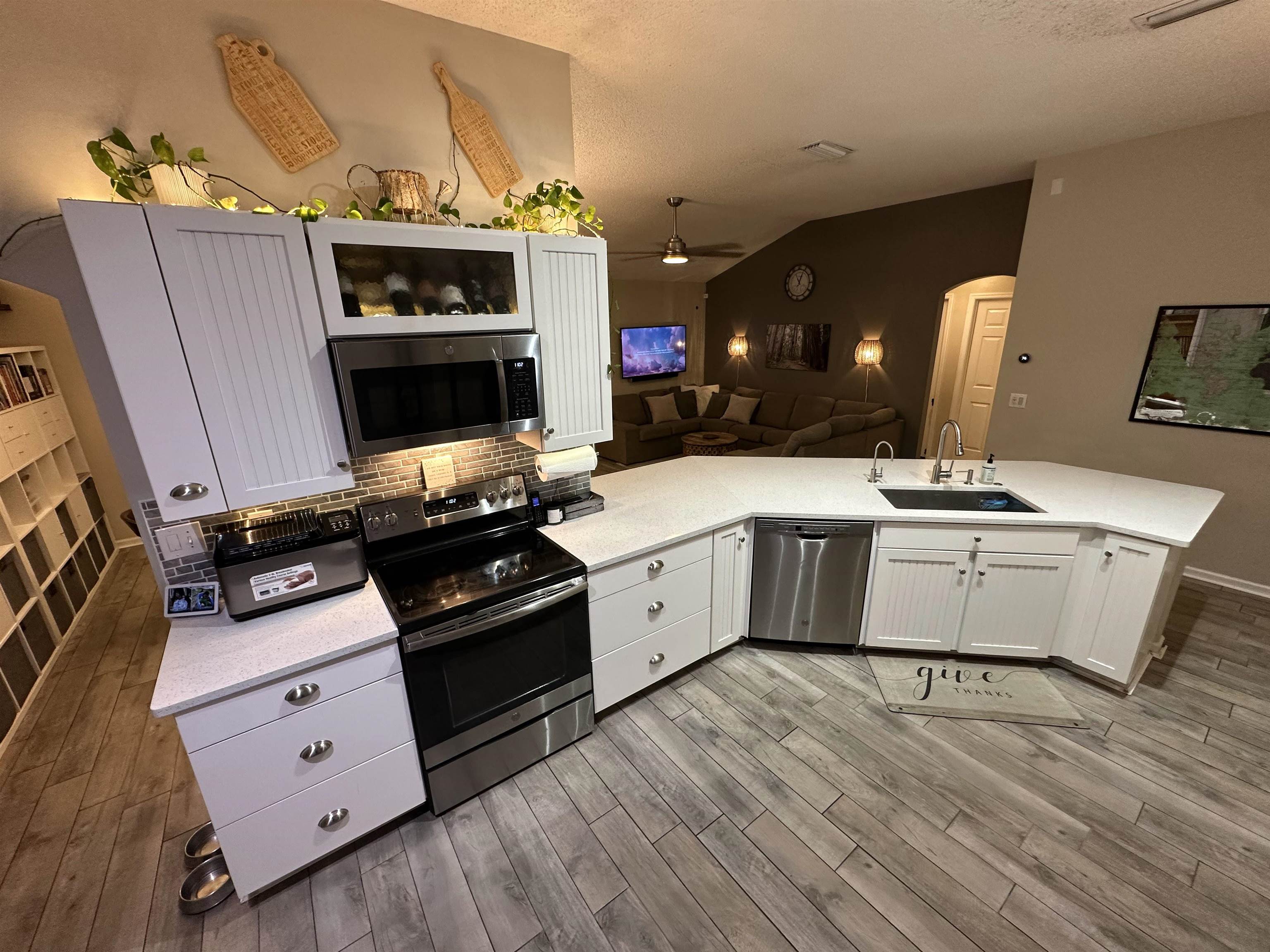 921 Oak Arbor Circle St. Augustine, FL 32084 - Photo 12 of 51 a kitchen with a stove wooden floor and a fireplace