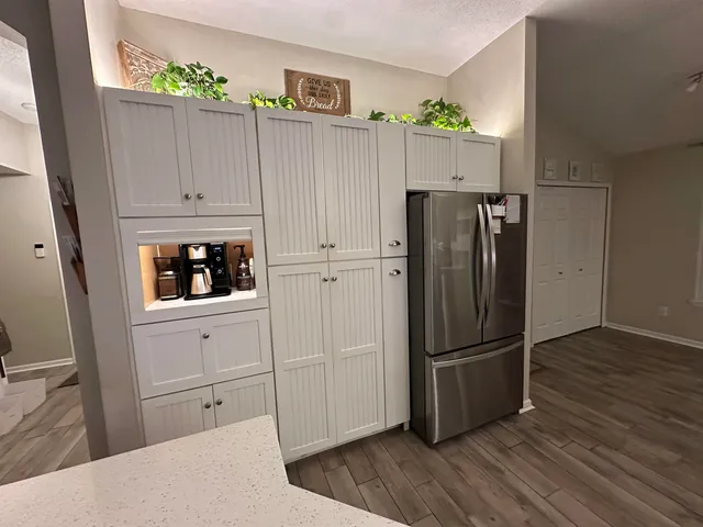 a kitchen with cabinets and stainless steel appliances