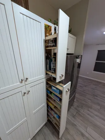 a view of a hallway with wooden floor and staircase