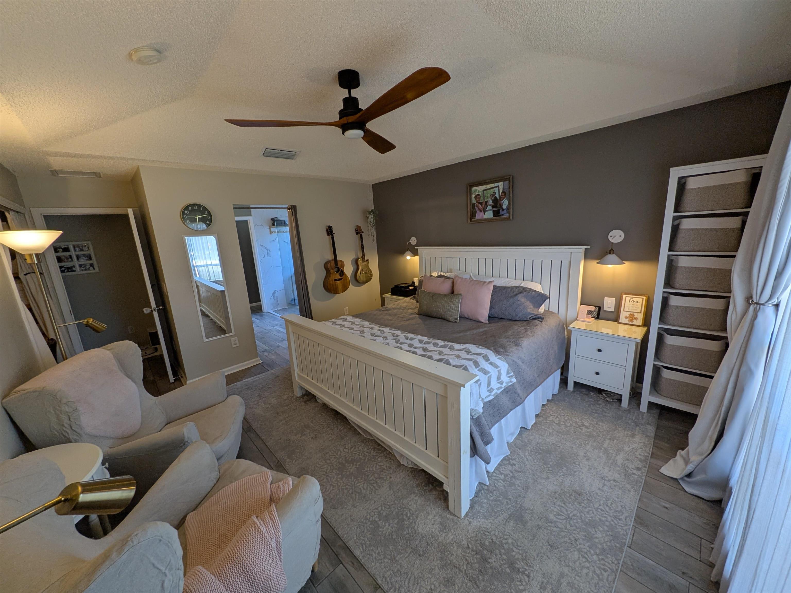 921 Oak Arbor Circle St. Augustine, FL 32084 - Photo 26 of 51 a bedroom with a bed a couch and a ceiling fan