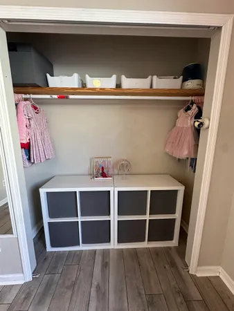 a living room with a bed and paintings on the wall