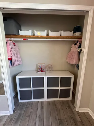 a living room with a bed and paintings on the wall