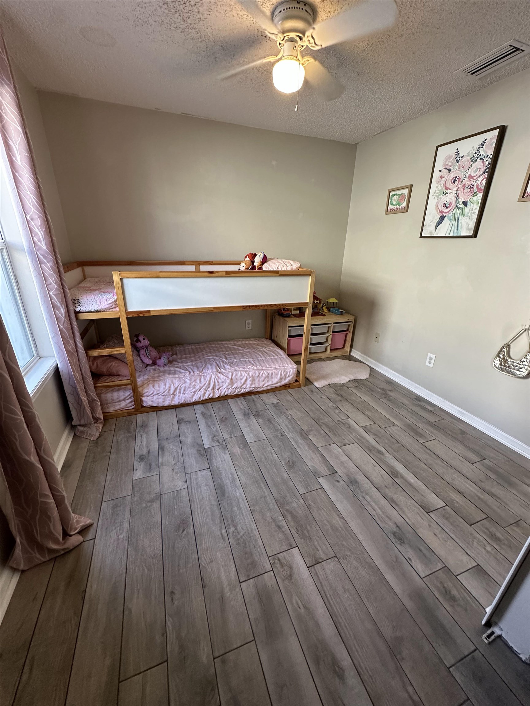 921 Oak Arbor Circle St. Augustine, FL 32084 - Photo 46 of 51 a living room with a bed and paintings on the wall