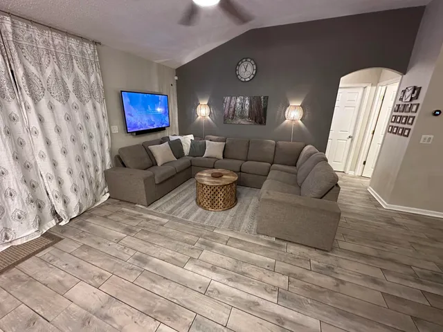 a living room with furniture and a fireplace