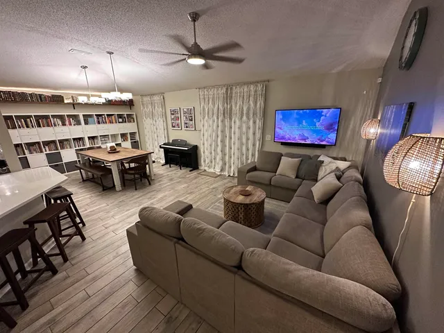 a living room with furniture a fireplace and a flat screen tv