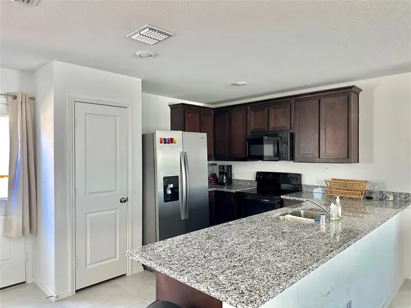 a kitchen with refrigerator and cabinets