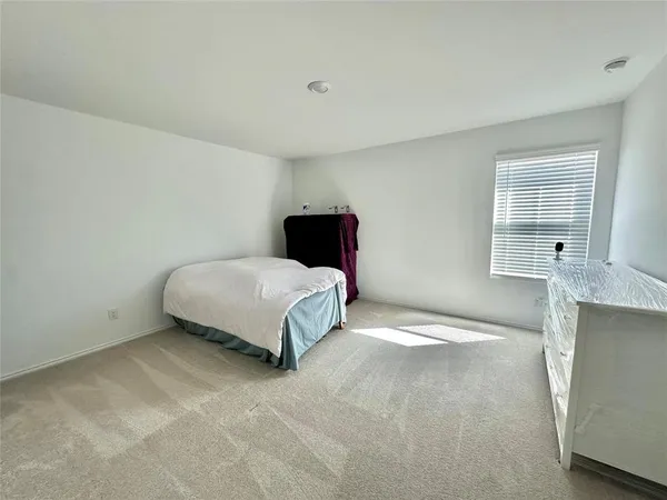 a bedroom with a bed and window
