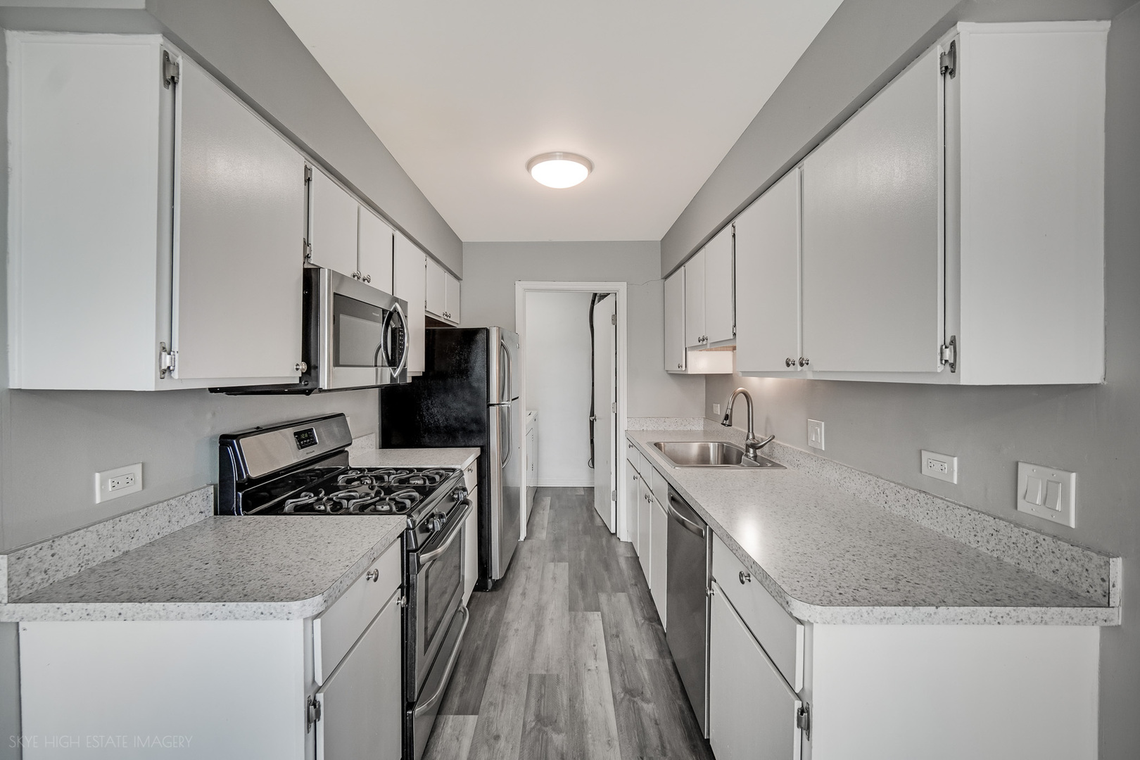 103 Red Barn Road, Unit 103 Matteson, IL 60443 - Photo 5 of 17 a kitchen with stainless steel appliances granite countertop a stove top oven a sink a refrigerator and white cabinets