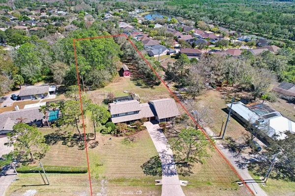 an aerial view of a house with a yard