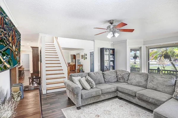 a kitchen with stainless steel appliances kitchen island granite countertop a stove and white cabinets