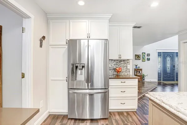 a view of a hallway to a livingroom with furniture and floor to ceiling window